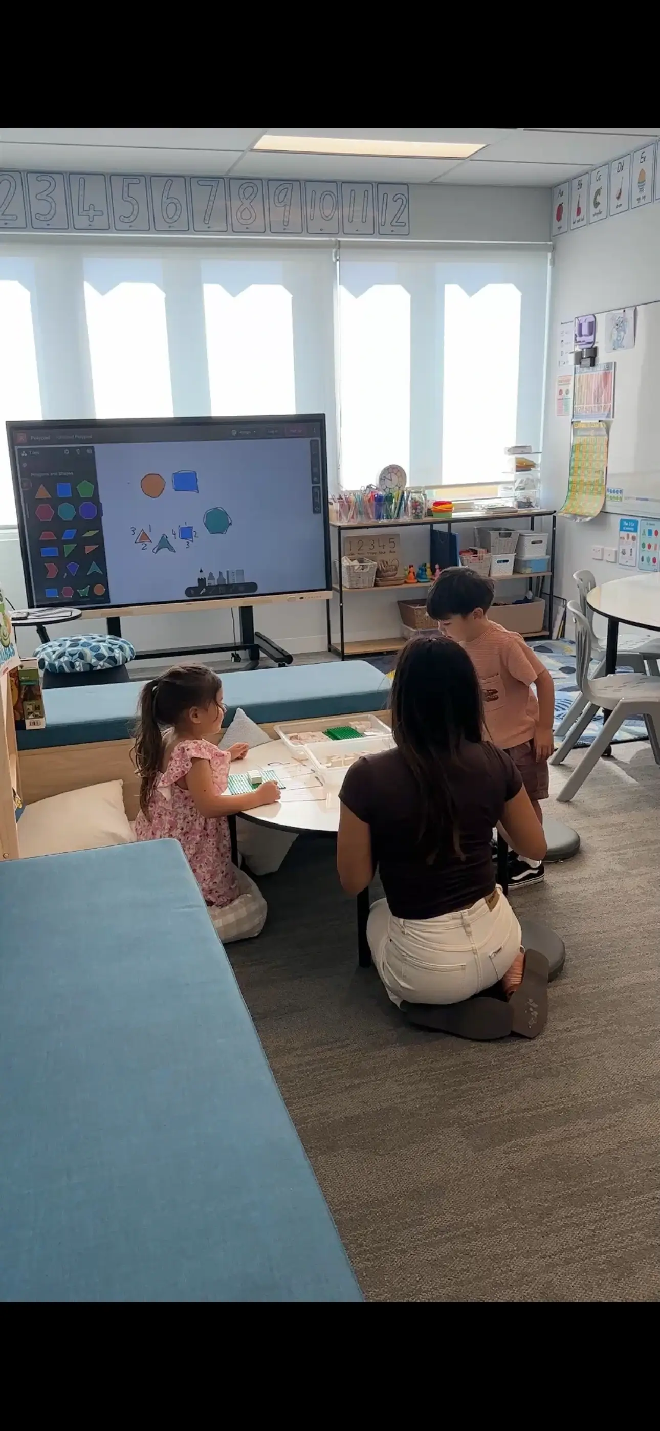 Tutor working closely with students at New Era Education